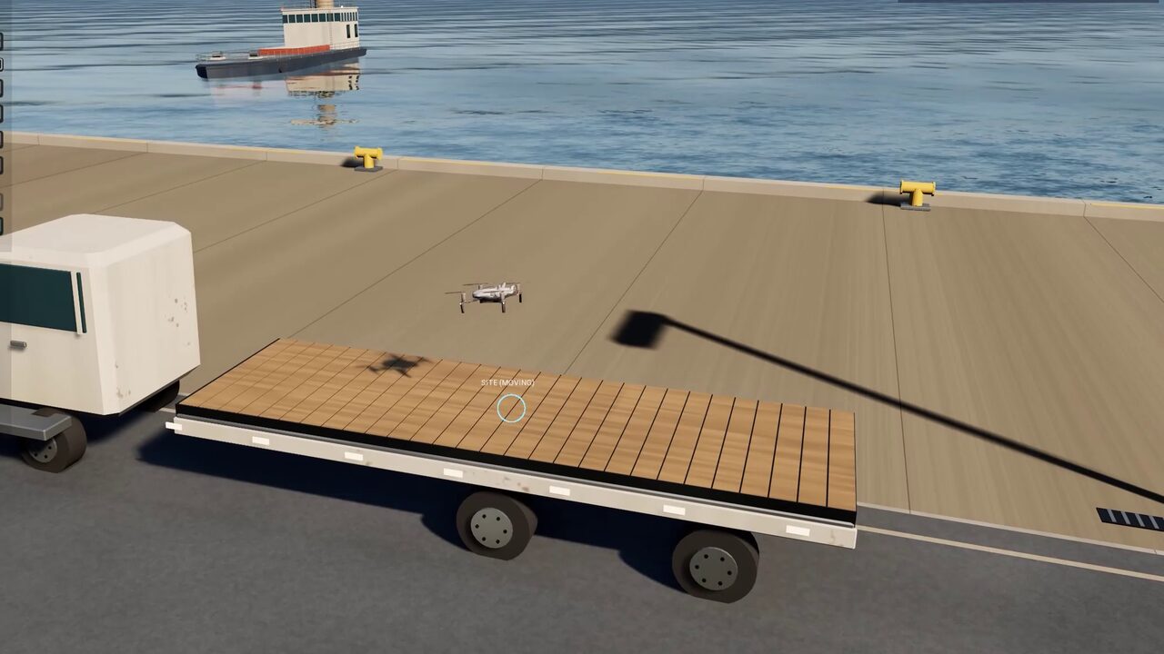 A drone lands on the flatbed of a moving lorry on the harbour quay